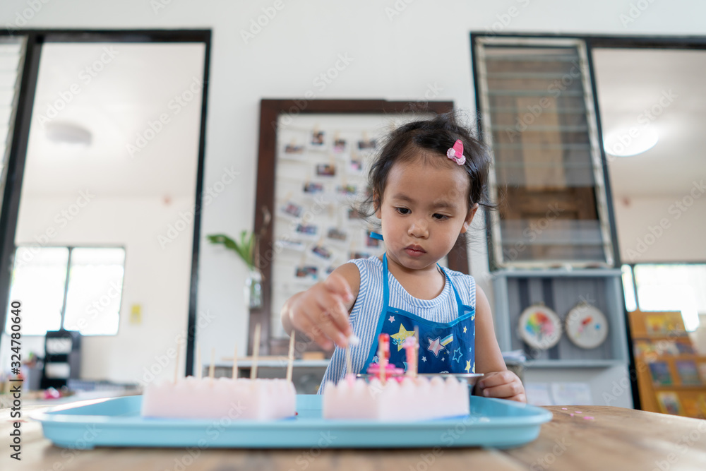 Cute little girl concentrated playing at kindergarten. Cute little girl concentrated playing at kindergarten.