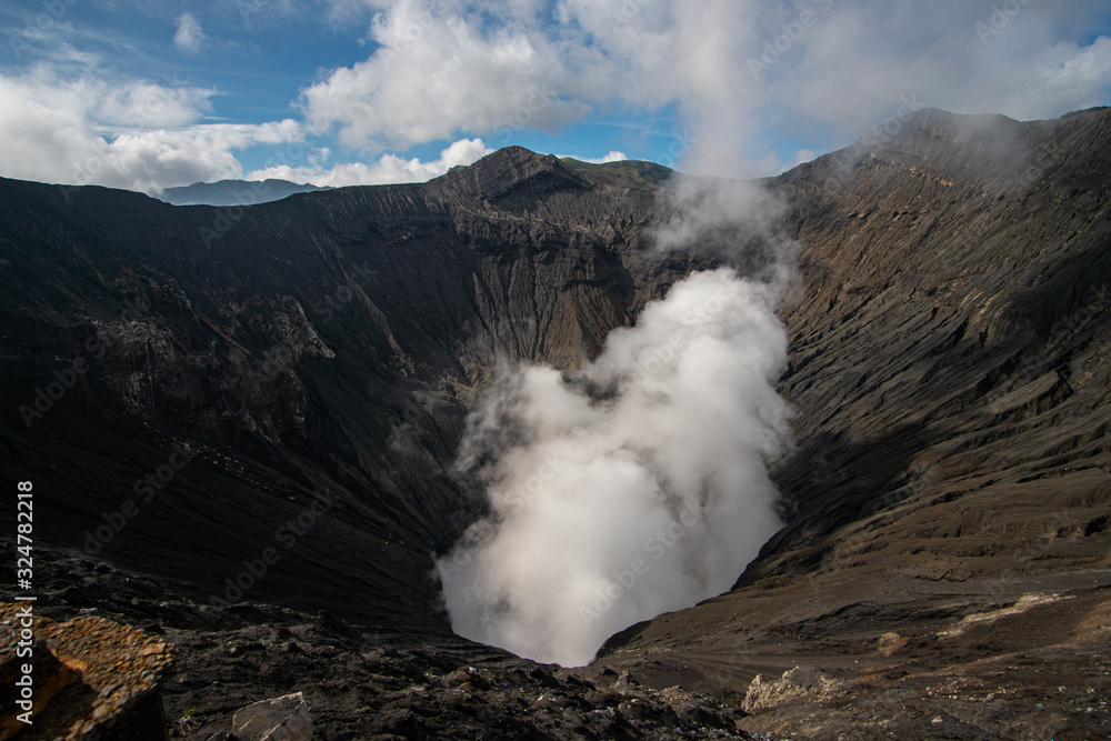 Mount Bromo from the top view down into the crater with the smoke coming up on Java Indonesia