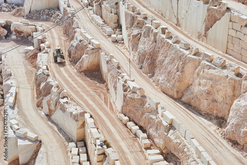 Tableau sur toile Mining industry: heavy duty Bulldozer in a marble quarry terraces
