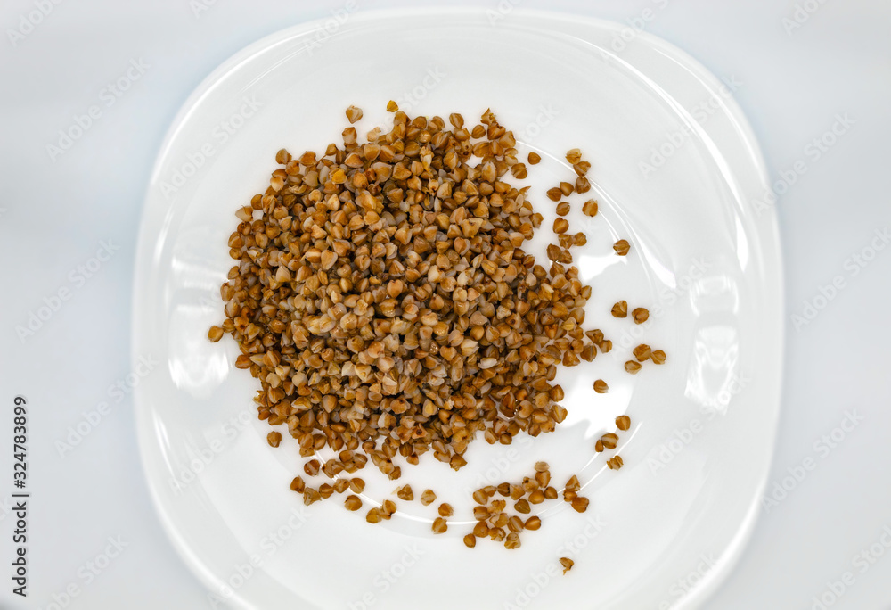 Top view of fresh buckwheat, which is in a white plate and dressed with linseed oil Top view of fresh buckwheat, which is in a white plate and dressed with linseed oil