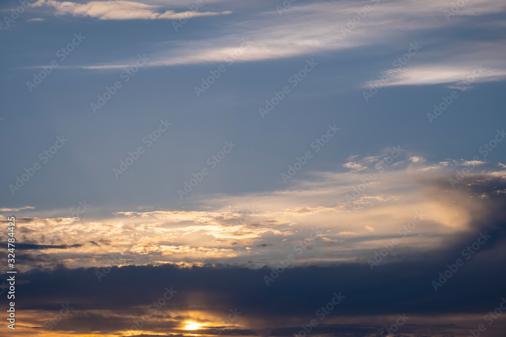 Beautiful sunset with cloudy sky background.
