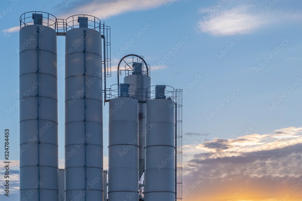 Concrete factory. Cement factory on a cloudy sky background.