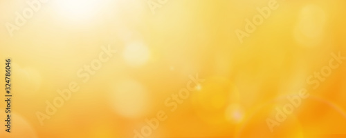 Bright yellow and gold bokeh summer sun abstract sky background.