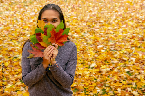 Woman holding autumn leaves. Beautiful autumn nature. Yellow autumn golden leaves. Thanksgiving day. Bright fall leaves.