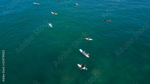 Aerial view of Canggu beach with surfers on Canggu beach located in the west of Bali