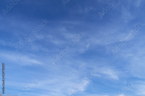 Bright beautiful blue sky with soft clouds for background or texture