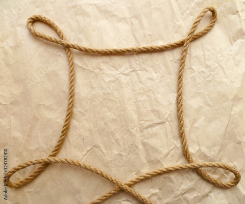 Hemp rope frame isolated on wrapping paper background. Marine design symbol. Nautical rope art. 