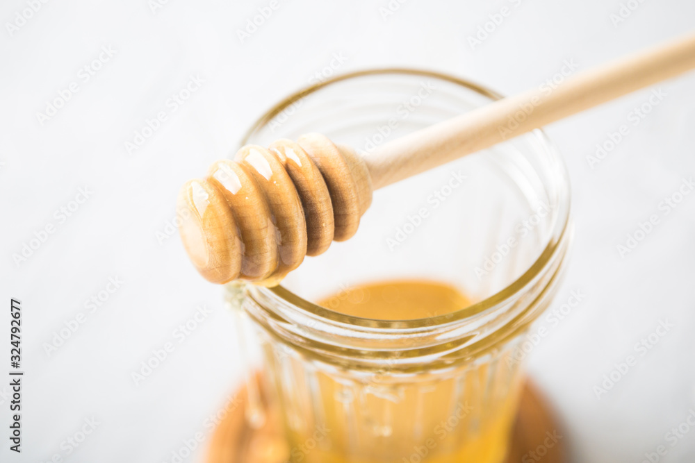 Natural flower honey in a glass jar Natural flower honey in a glass jar