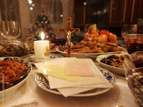 Lithuanian Christmas Eve table with Christmas wafers, candle and various dishes