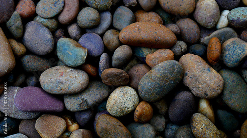 pebbles on the beach stone background. color stone