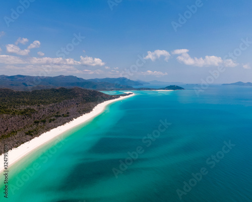 Tropical beach paradise. Whitsundays aerial view, with turquoise ocean, white sand. Dramatic DRONE from above. Travel, holiday, vacation, paradise concepts. Whitsundays Islands, Queenstown, Australia.