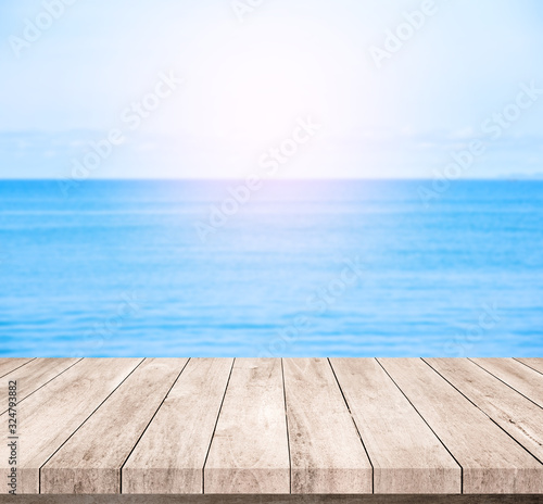 wood table or wood floor with blue sea scape background for product display