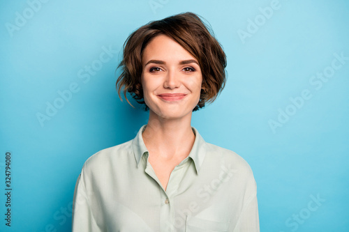 Closeup photo of attractive cute business lady short bob hairstyle smiling good mood responsible person wear casual formalwear green shirt isolated blue color background