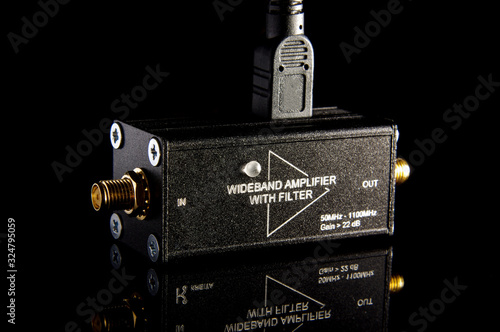 RF wideband amplifier isolated on the black background photo