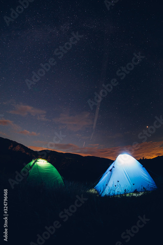 Tents in the night with the milky way. Wanderlust and travel concept. 