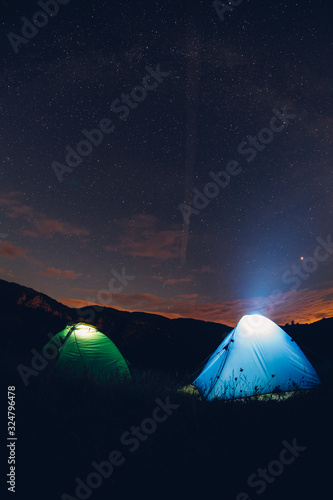 Tents in the night with the milky way. Wanderlust and travel concept. 