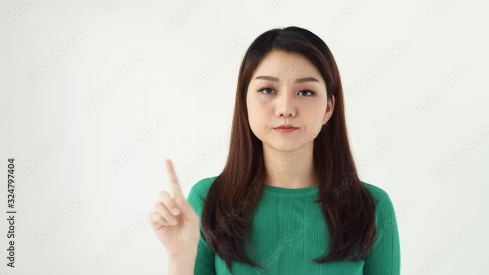 Young beautiful woman standing and say no isolated over light background while looking camera. Young beautiful woman standing and say no isolated over light background while looking camera.