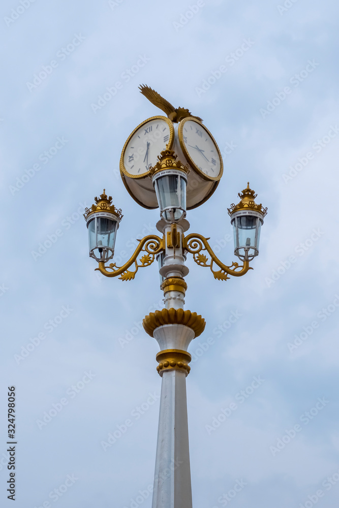 Classic style streeet clock. Street retro clock with a bird on sky background. Classic style streeet clock. Street retro clock with a bird on sky background.