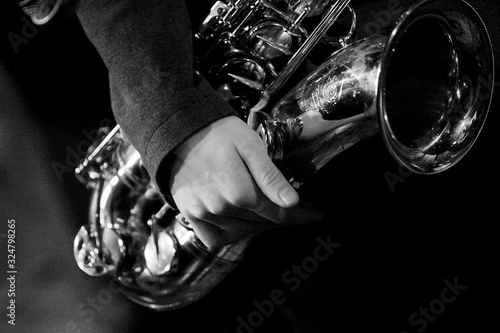 Hands of tenor saxophone player on the stage photo