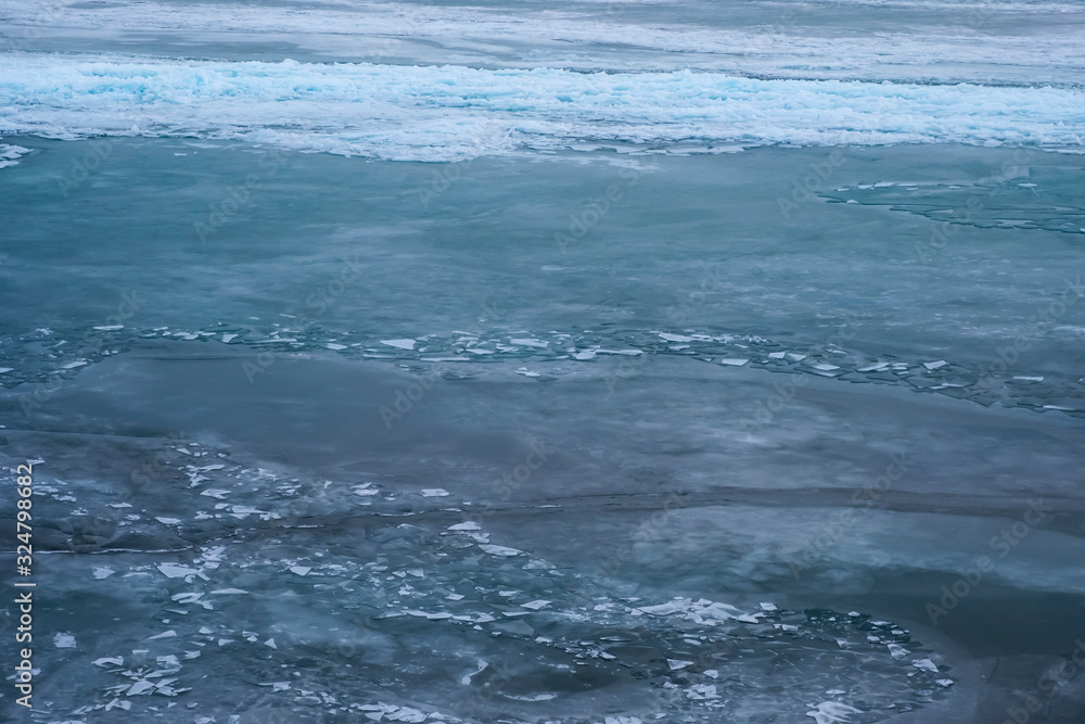 Field of ice hummocks on the frozen lake. Cracked ice on lake in winter season, natural landscape background. Field of ice hummocks on the frozen lake. Cracked ice on lake in winter season, natural landscape background.