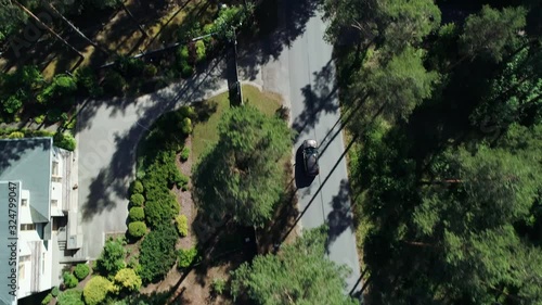 Birds view of car driving on country side during sunny summer day