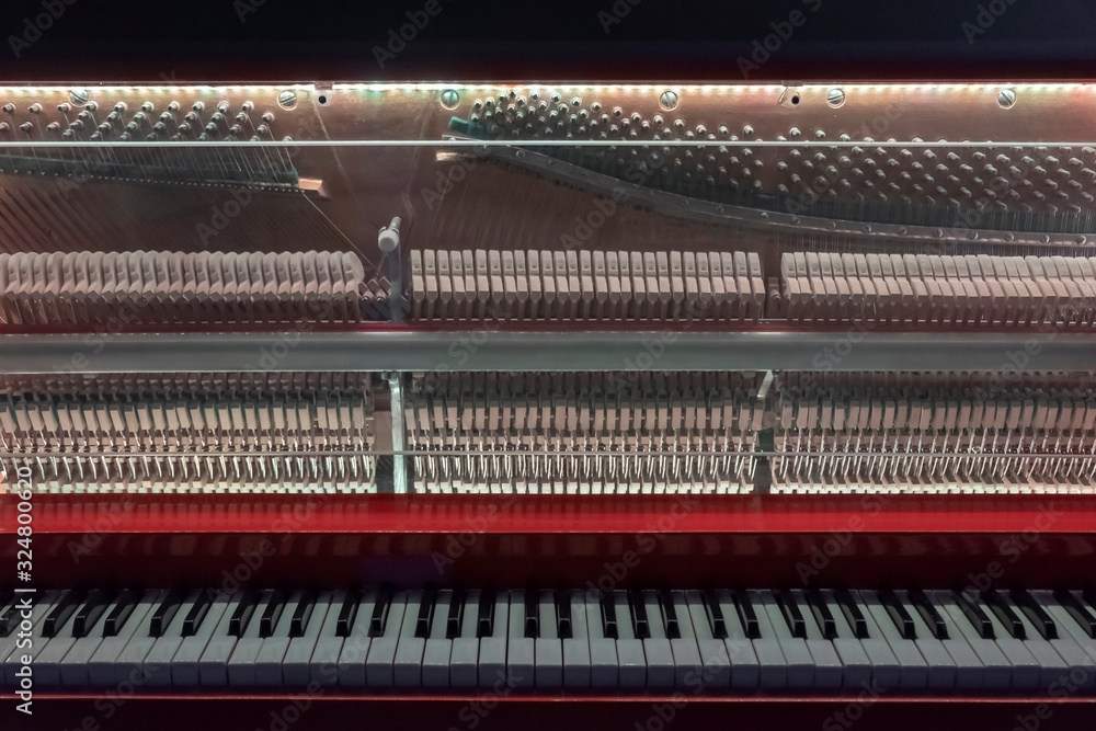 Piano with glass front cover. Piano keys and piano inside. Piano interior detail. Piano with glass front cover. Piano keys and piano inside. Piano interior detail.