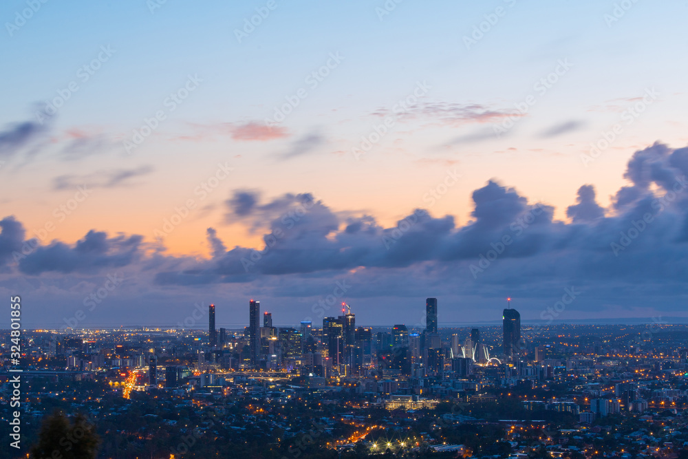 Brisbane skyline view at dawn with cloudy sky.