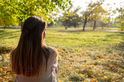 Woman is taking a rest in autumn park.