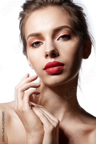 Close-up portrait of beautiful model with naked shoulders. Bright lips and natural makeup. 