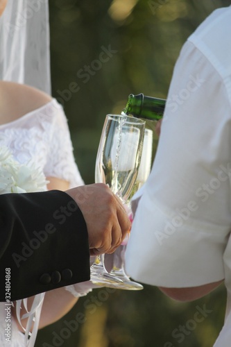 Champagne being poured into glasses for the bride and groom