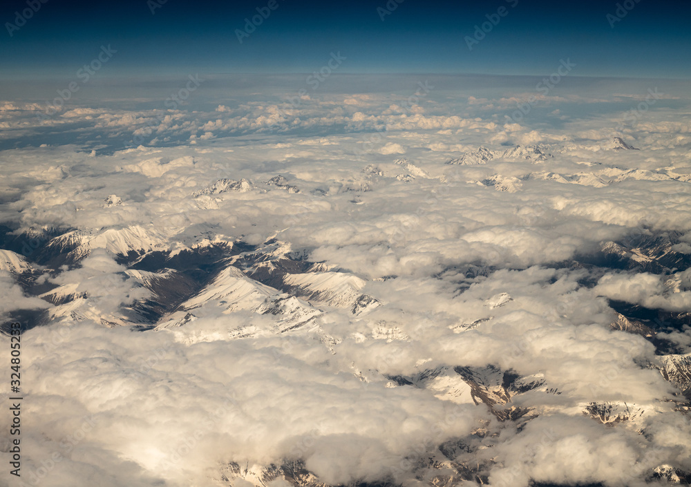 Naklejka premium Top View from plane to snow capped peaks of Caucasus Mountains
