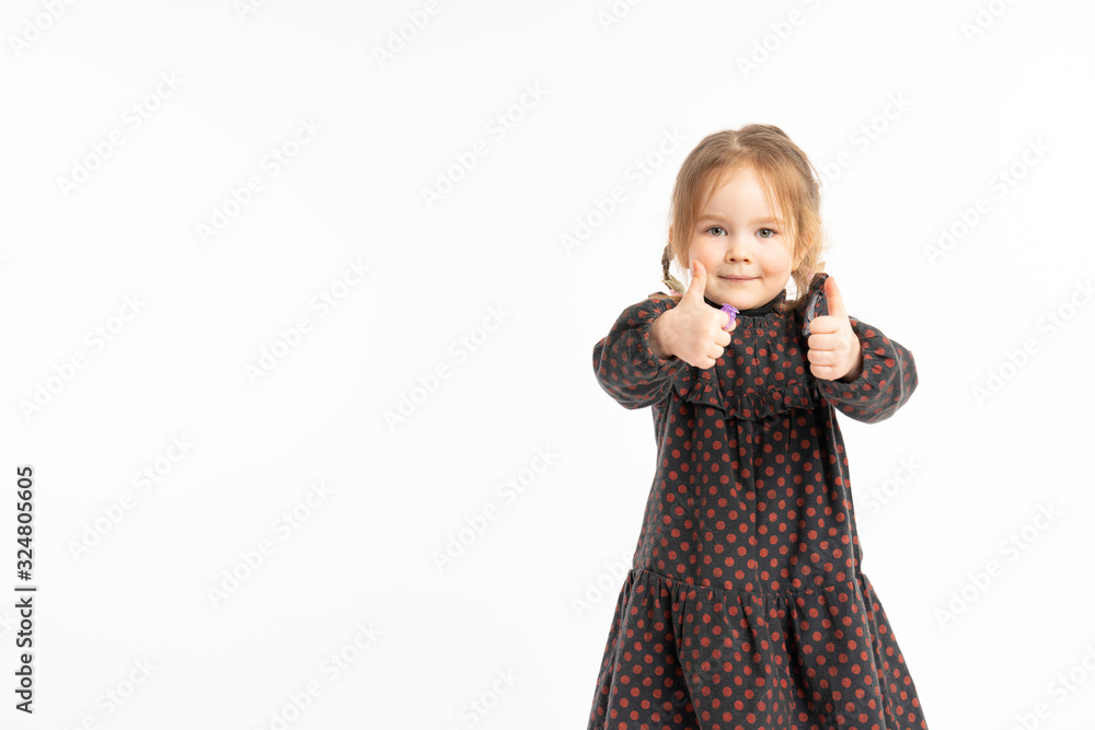 Cute redhead little girl in dress success sign doing positive gesture with hands, thumbs up smiling and happy. Looking at the camera with cheerful expression, winner gesture. Cute redhead little girl in dress success sign doing positive gesture with hands, thumbs up smiling and happy. Looking at the camera with cheerful expression, winner gesture.
