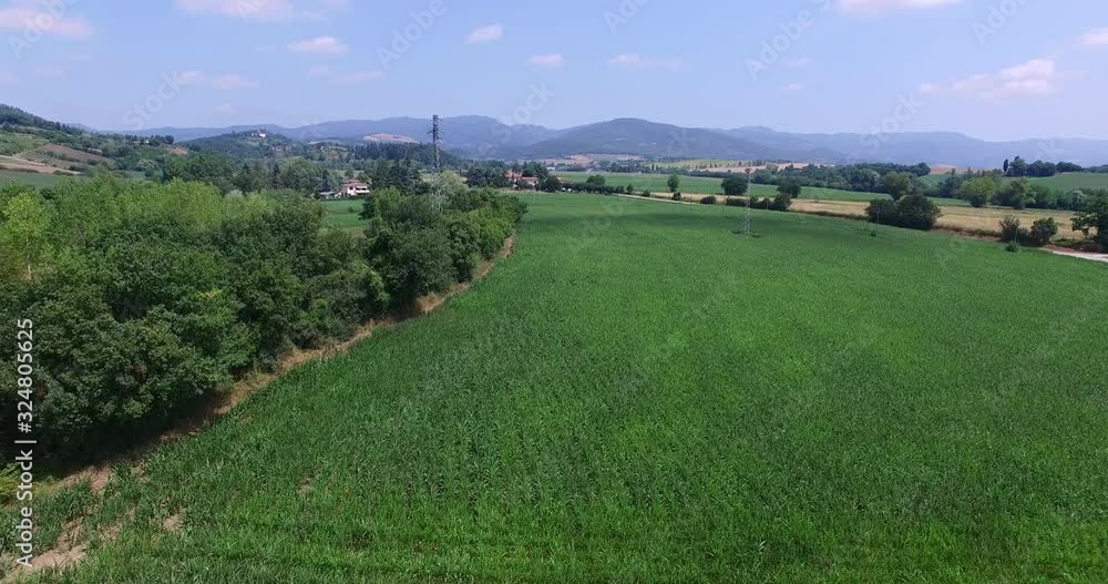 Drone flying through the tuskany in italy, crop fields below and green landscape all around. Drone flying through the tuskany in italy, crop fields below and green landscape all around.