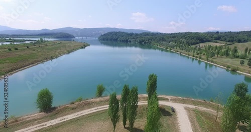 Aerial approach of the coastline of a lake in the Tuskany in Italy on a sunny day. photo