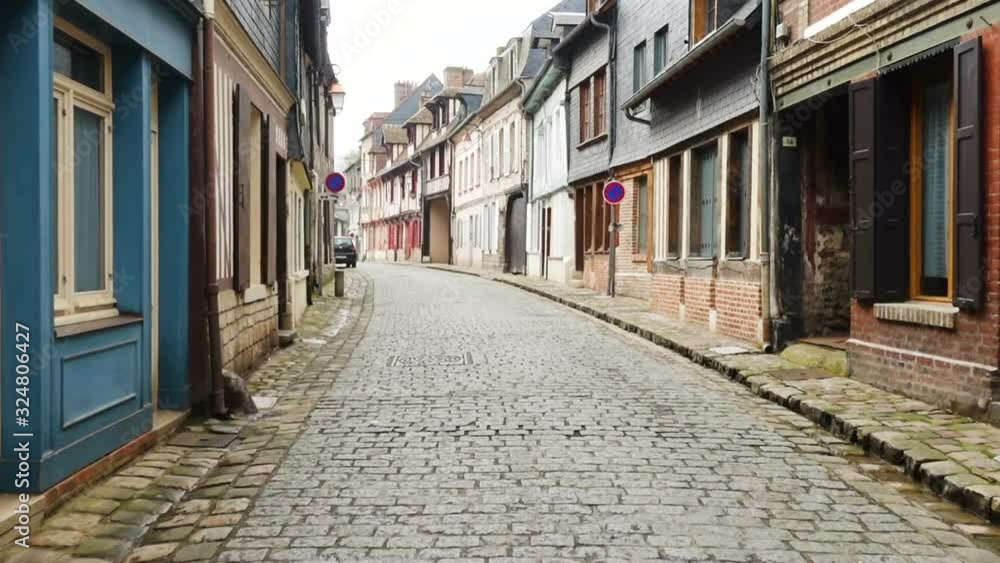 HONFLEUR, FRANCE - APRIL 08, 2018: view of empty beautiful street with old traditional houses at the center of Honfleur, Normandy, France