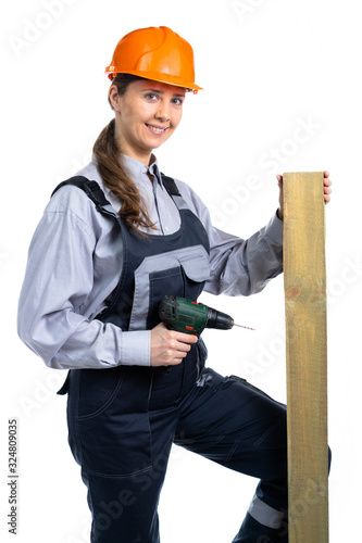 Girl builder with a wooden board in her hands and a screwdriver. isolated © Andrey