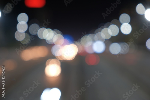 Blurred motion light of car headlamps headlights, soft focus.  Multicolor bokeh,blur focus. © Adil