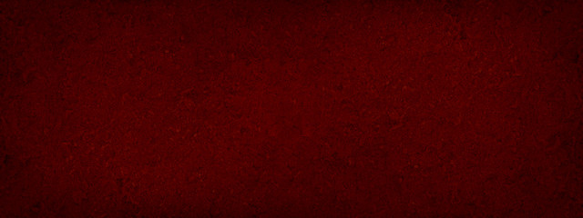Red abstract background. Toned fiberboard texture. Close-up. Burgundy vintage background. Wide banner. Dark red background with copy space for your design.