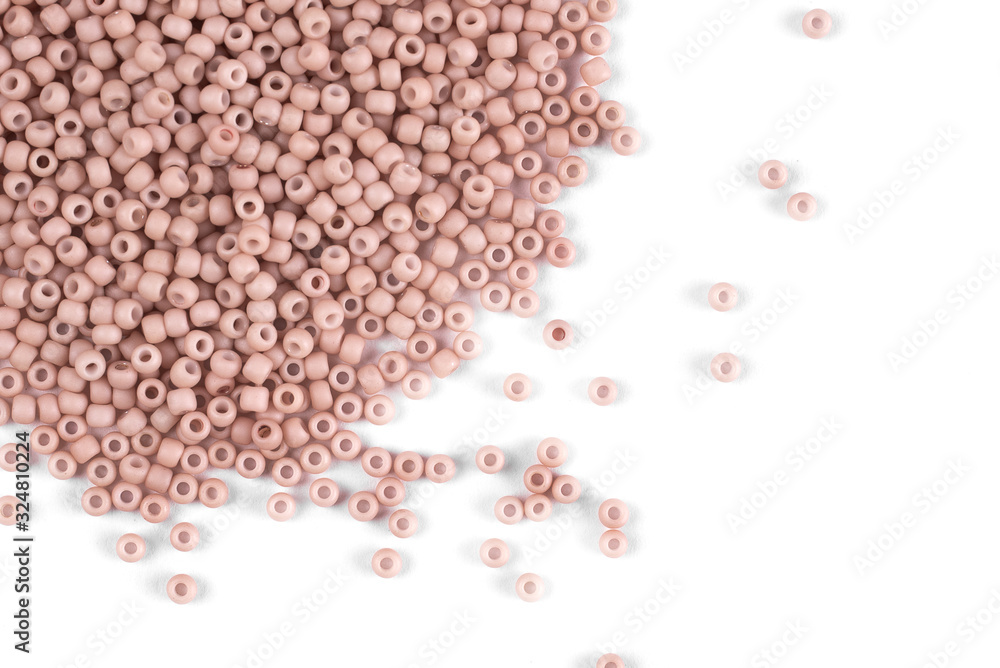 Pink scattered beads on a white background, top view, costume jewelry Pink scattered beads on a white background, top view, costume jewelry