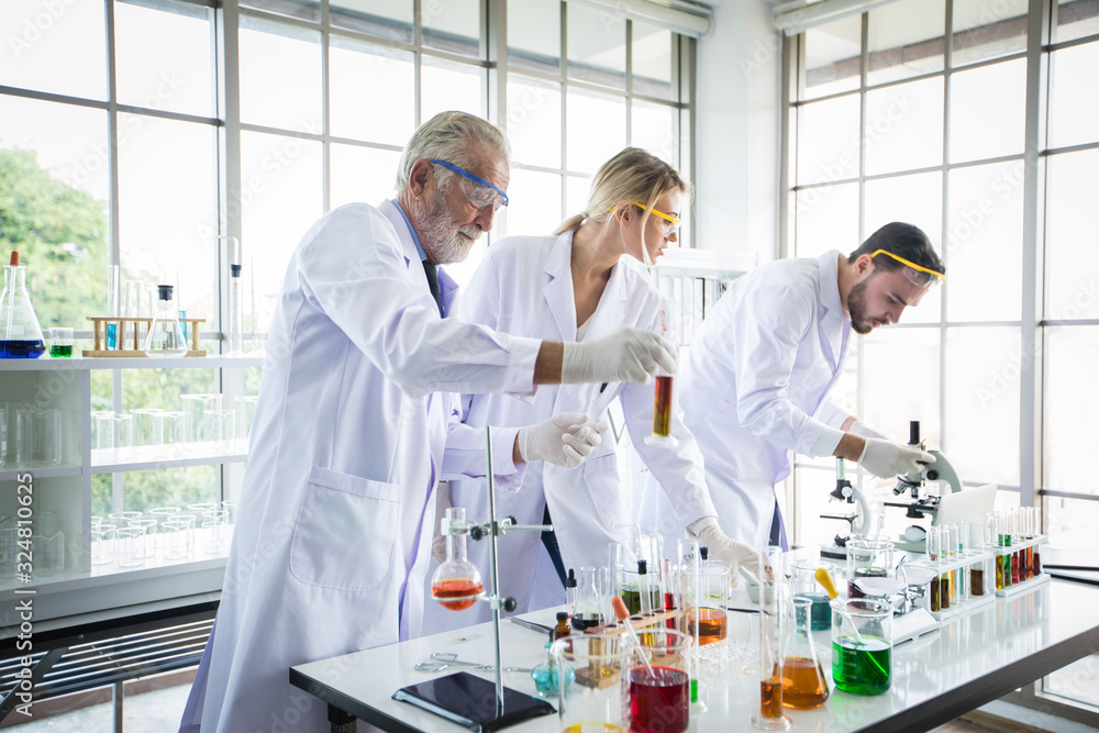 Medical Research and Scientists are working with a microscope and a tablet and Test Tubes, Micropipette and Analysis Results in a laboratory. Medical Research and Scientists are working with a microscope and a tablet and Test Tubes, Micropipette and Analysis Results in a laboratory.