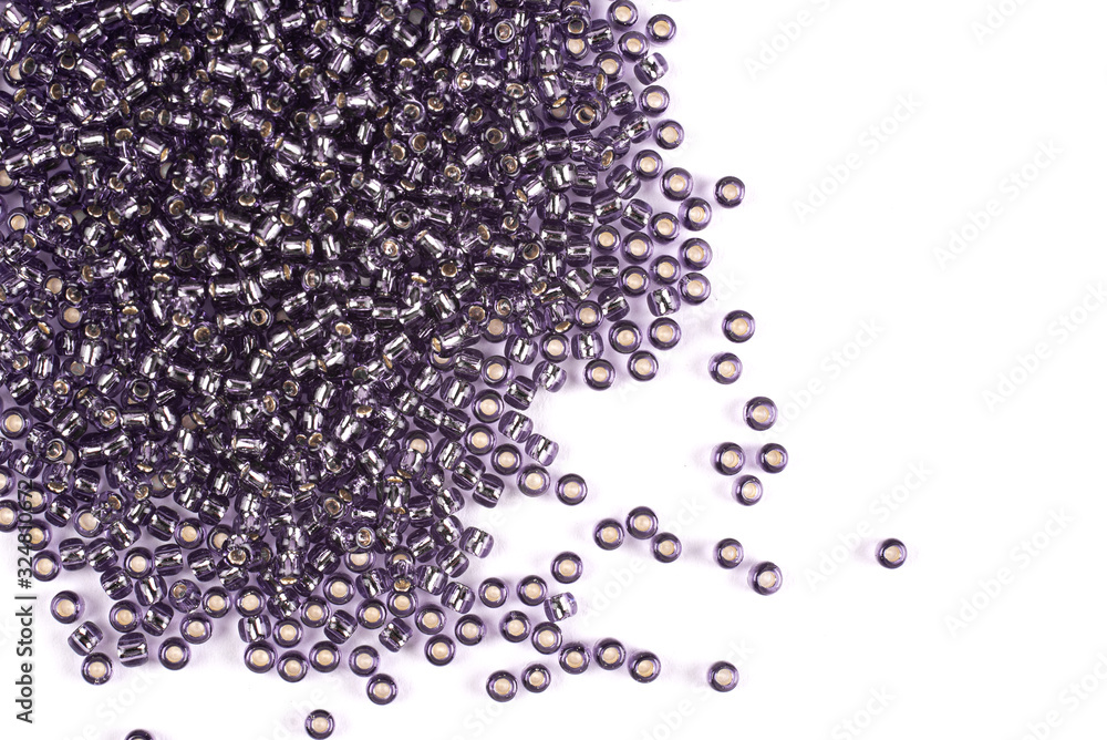 Blue beads scattered beads on a white background, top view, costume jewelry Blue beads scattered beads on a white background, top view, costume jewelry