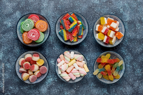 Colorful candies, jelly and marmalade on dark grey background,top view