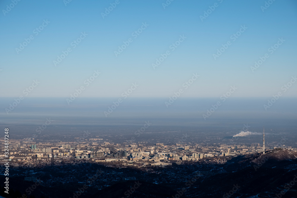 Almaty city captured from mountains. Morning in winter Almaty.