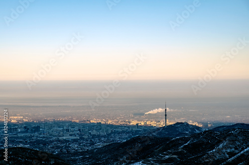 Almaty city captured from mountains. Morning in winter Almaty. © Adil