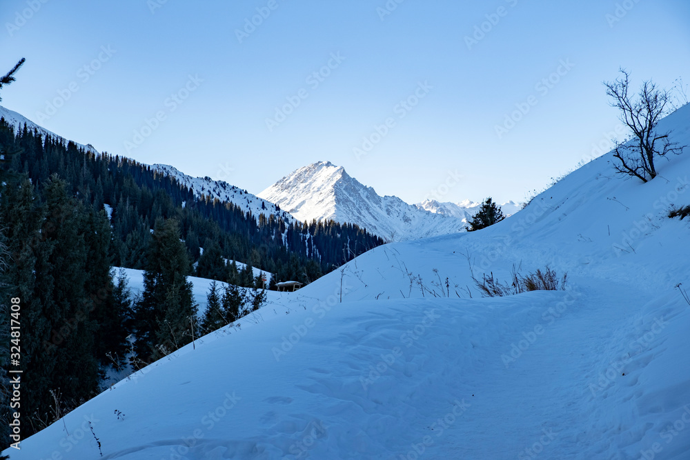 Trail in mountains in winter day.