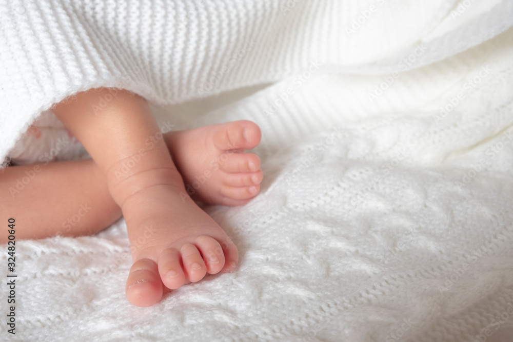Newborn baby feet. Tiny cute feet on a white blanket. Newborn baby feet. Tiny cute feet on a white blanket.