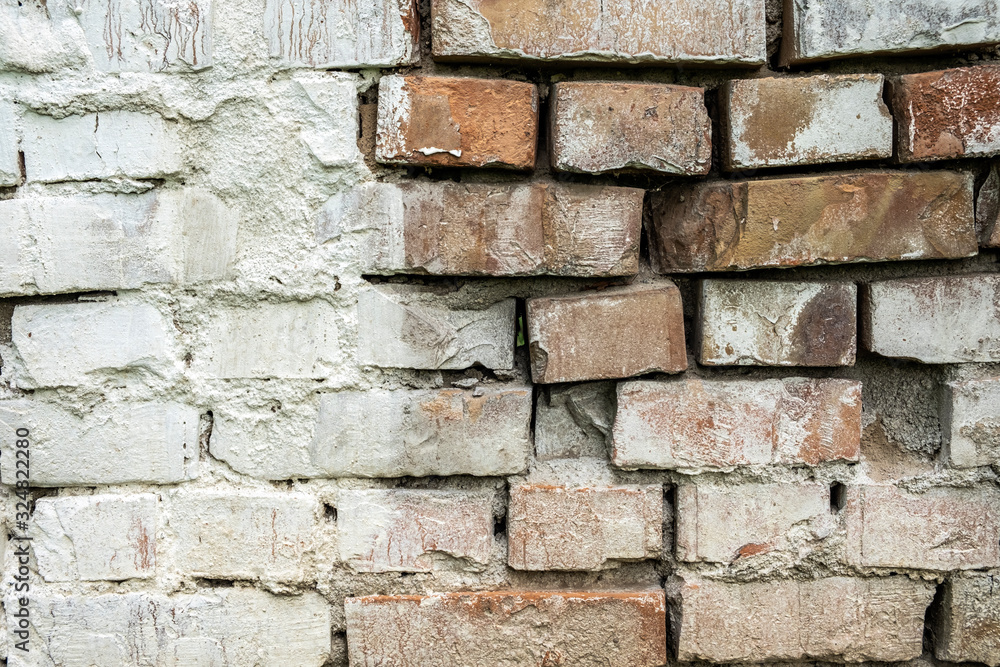 Old damaged brick wall with plaster background texture. Old damaged brick wall with plaster background texture.