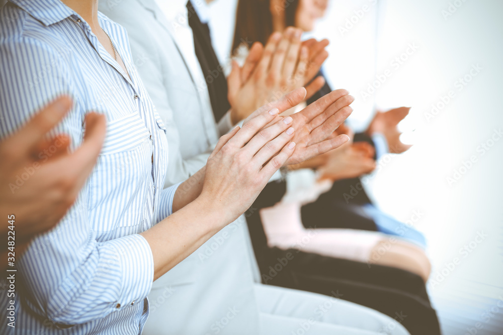 Business people clapping and applause at meeting or conference, close-up of hands. Group of unknown businessmen and women in modern white office. Success teamwork or corporate coaching concept Business people clapping and applause at meeting or conference, close-up of hands. Group of unknown businessmen and women in modern white office. Success teamwork or corporate coaching concept