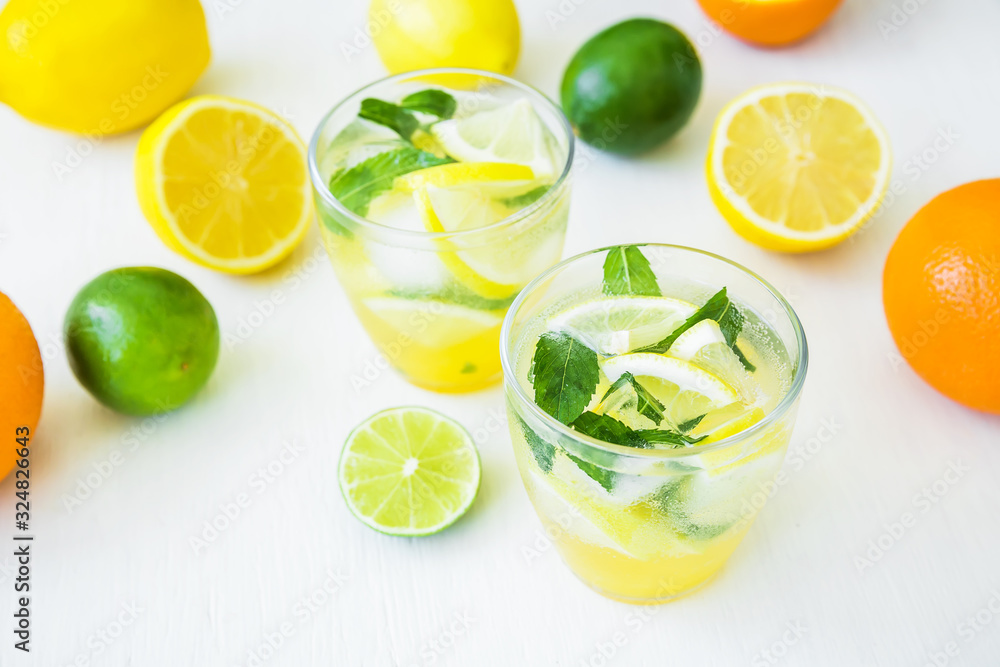 Citrus cold lemonade with lime, mint and lemons in glasses Citrus cold lemonade with lime, mint and lemons in glasses
