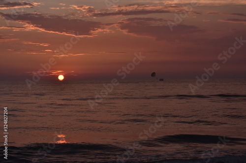 parasailing in ocean during sunset in Goa © SUBHAJIT